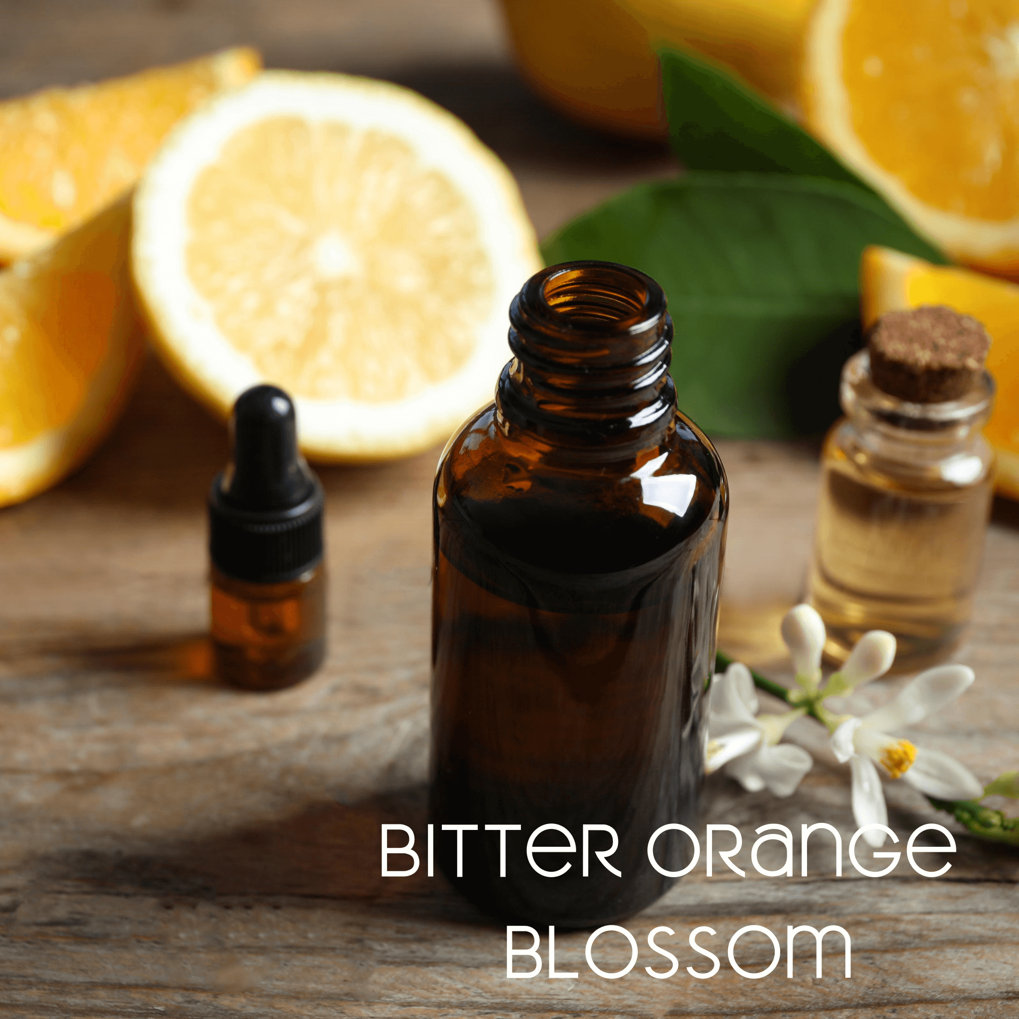 Amber bottle of Bitter Orange oil and sliced Bitter Oranges contain ingredient of “Kindle”, an energizing mat refresh spray.