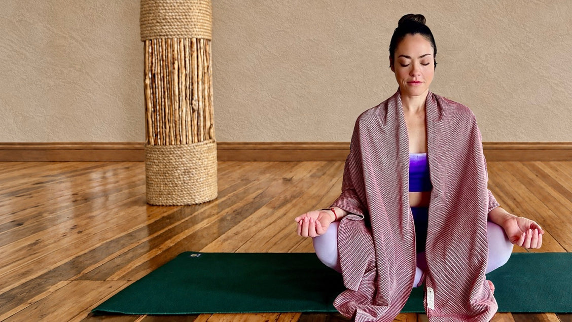 Woman seated in meditation on an Earthmat, wrapped in a Kinshē Earthtowel